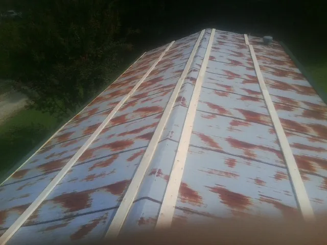Rusted metal roof panels with new wood purlins before replacement — Storm Damage Roof Repair in Forest Hill by Roofing Brothers