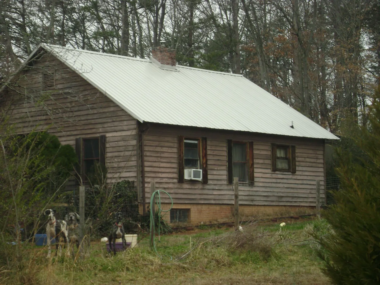 White metal roof on an old wood sided farmhouse, from a Asphalt Shingle Roof Repair job in Forest Hill